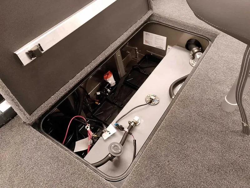 Slide: The Image of 2025 Ranger RT178 SC boat storage compartment with wiring and fuel tank. - 30