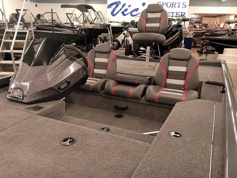 Slide: The Image of 2025 Ranger RT178 SC boat interior with gray and red seating in showroom. - 6