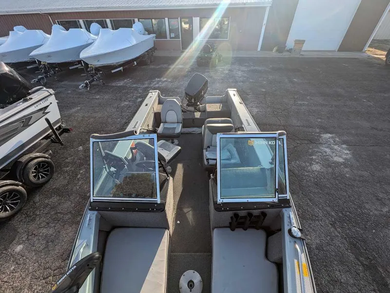 Slide: The Image of 1996 Lund 1700 Pro Sport Adventure boat, parked outdoors with covered boats in the background. - 3