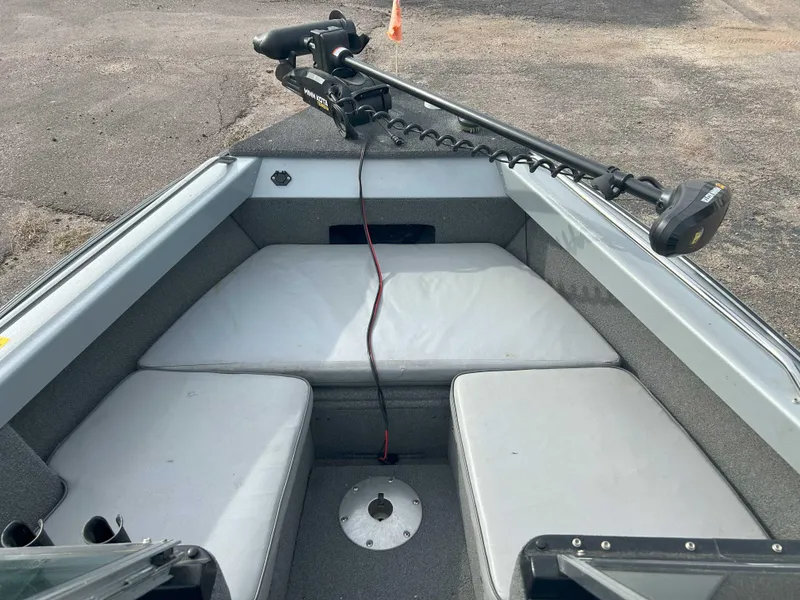 Slide: The Image of 1996 Lund 1700 Pro Sport Adventure boat interior with seating and trolling motor. - 5