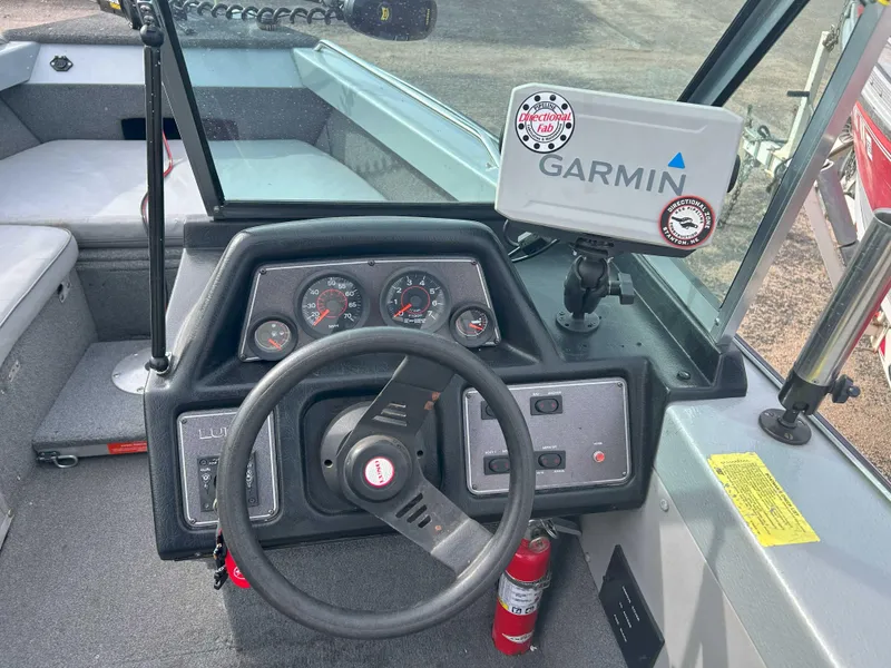 Slide: The Image of 1996 Lund 1700 Pro Sport Adventure boat dashboard with Garmin GPS and steering wheel. - 6