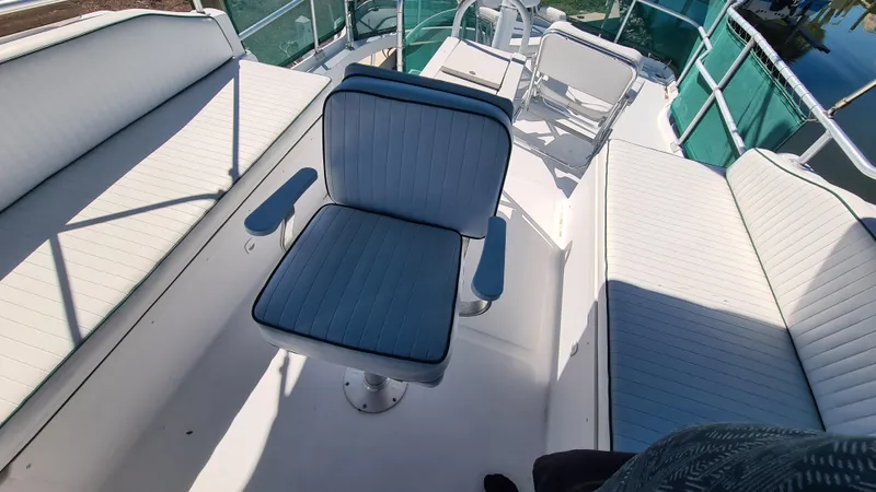 Slide: The Image of 1999 Mainship 350 Trawler deck with cushioned seating and helm chair. - 12