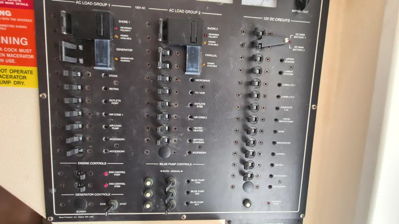 Slide: The Image of Control panel of a 1999 Mainship 350 Trawler, featuring various switches and indicators. - 26