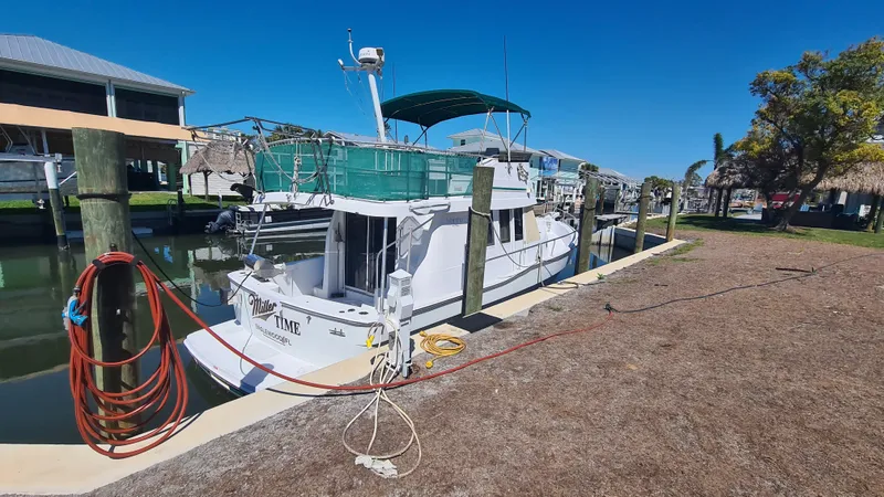 Slide: The Image of 1999 Mainship 350 Trawler docked at marina under clear blue sky. - 3