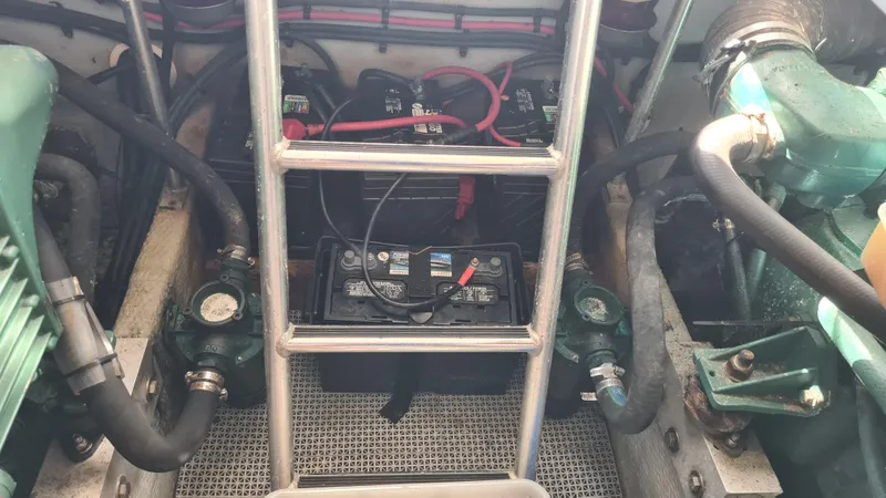 Slide: The Image of Engine compartment of a 1999 Mainship 350 Trawler with visible batteries and wiring. - 30