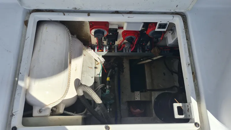 Slide: The Image of Engine compartment of a 1999 Mainship 350 Trawler, showing mechanical components and wiring. - 31