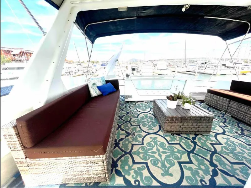Slide: The Image of Luxurious Shaw 57 yacht interior with stylish seating and patterned rug, 1994 model. - 18