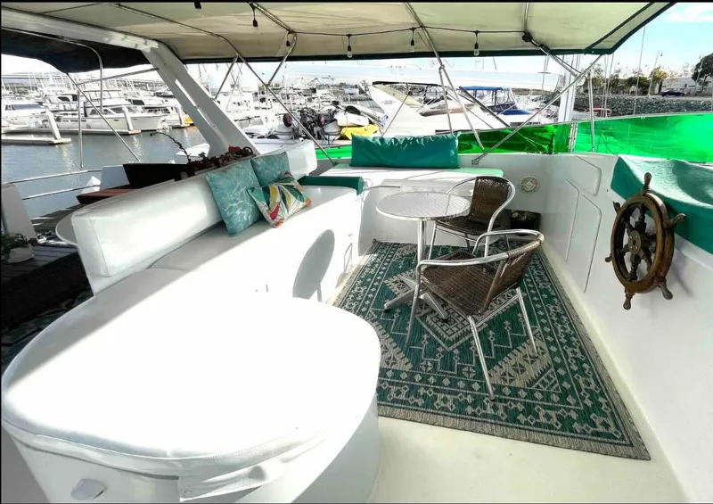 Slide: The Image of Luxurious 1994 Shaw 57 yacht deck with seating, table, and nautical decor. - 19