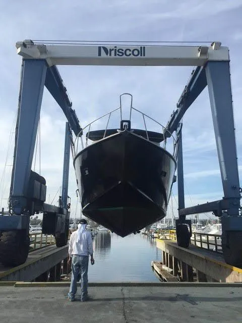 Slide: The Image of Boat being lifted by Driscoll crane at marina; Shaw 57, 1994 model. - 21