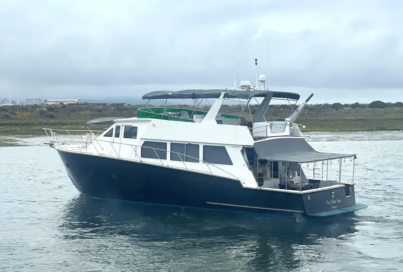 Slide: The Image of Shaw 57 yacht from 1994 on calm waters, featuring a sleek design and spacious deck. - 5