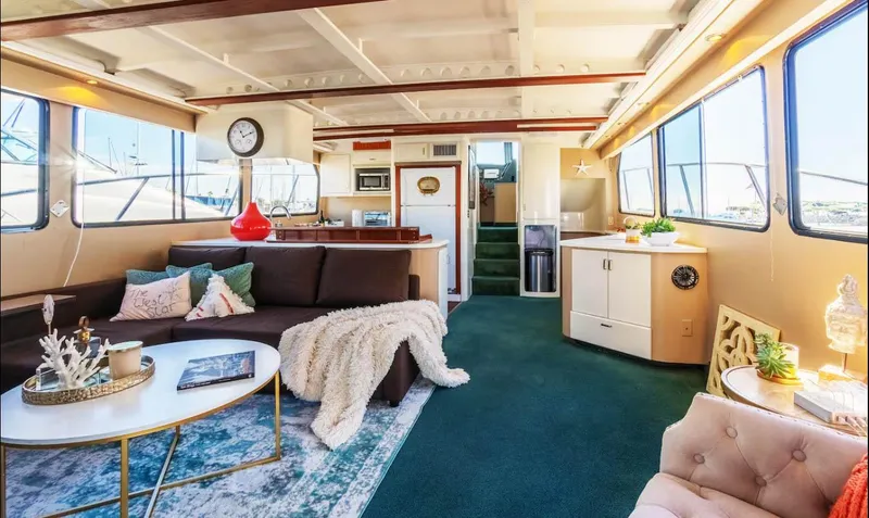 Slide: The Image of Luxurious 1994 Shaw 57 yacht interior with cozy seating, modern decor, and large windows. - 7