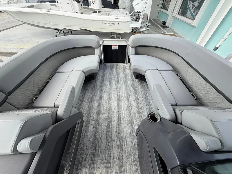 Slide: The Image of 2025 Bennington 22 MFB pontoon boat interior with gray seating and carpet flooring. - 17
