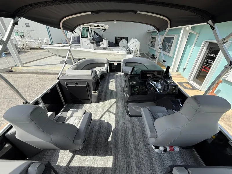 Slide: The Image of 2025 Bennington 22 MFB pontoon boat interior with gray seating and modern dashboard. - 8