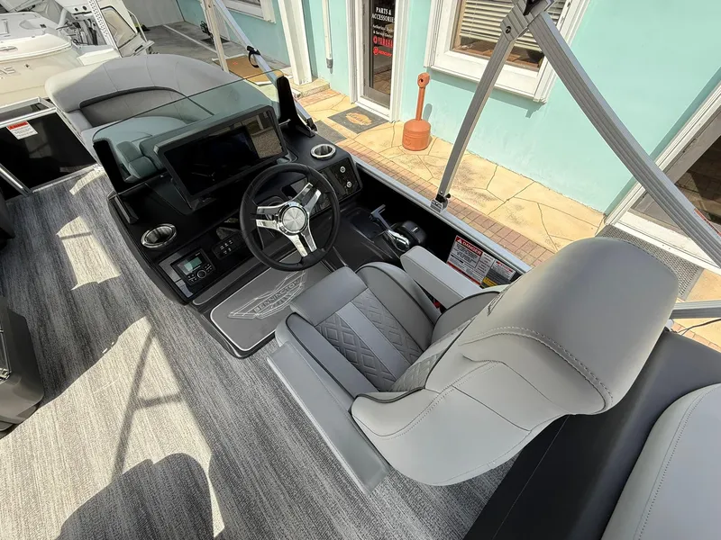 Slide: The Image of 2025 Bennington 22 MFB boat cockpit with modern steering and seating. - 9