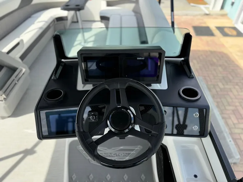 Slide: The Image of 2025 Bennington 26 MSB boat dashboard with steering wheel and digital displays. - 13