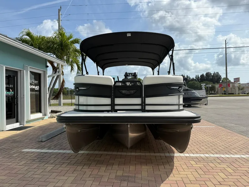 Slide: The Image of 2025 Bennington 26 MSB pontoon boat parked on brick pavement, under a clear sky. - 2