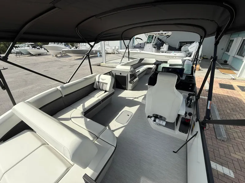 Slide: The Image of 2025 Bennington 26 MSB boat interior with spacious seating and modern helm. - 7
