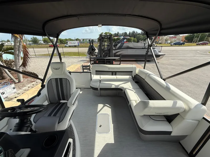 Slide: The Image of 2025 Bennington 26 MSB pontoon boat interior with seating and steering area. - 8