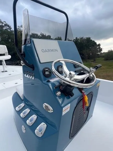 Slide: The Image of 2025 Blazer Bay 2200 boat console with Garmin system, steering wheel, and controls. - 11