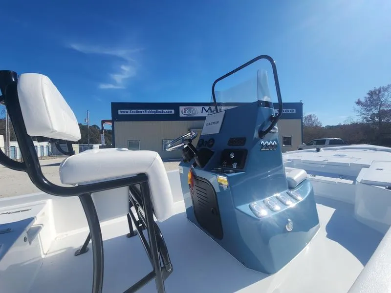 Slide: The Image of 2025 Blazer Bay 2200 boat console and seating under clear blue sky. - 13