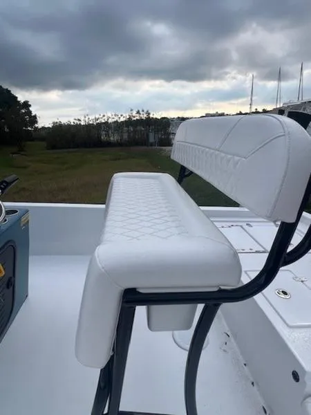 Slide: The Image of 2025 Blazer Bay 2200 boat with white seating, under a cloudy sky. - 18