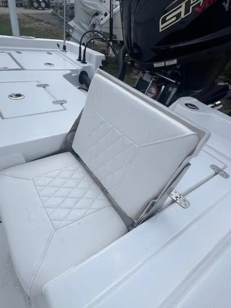 Slide: The Image of 2025 Blazer Bay 2200 boat with white cushioned seating and motor detail. - 19