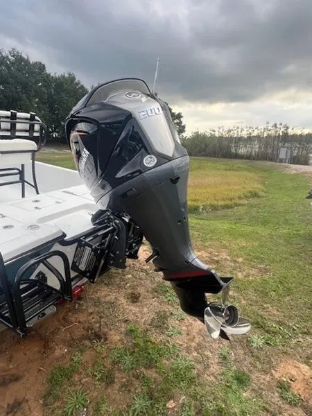 Slide: The Image of 2025 Blazer Bay 2200 boat with powerful outboard motor on grassy landscape. - 20