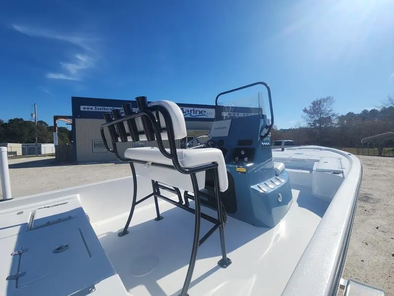 Slide: The Image of 2025 Blazer Bay 2200 boat with seating and console, parked outdoors under clear blue sky. - 21