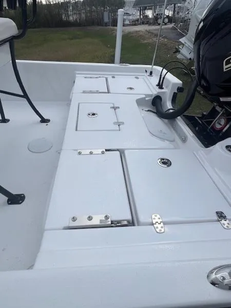 Slide: The Image of 2025 Blazer Bay 2200 boat deck with storage compartments and motor. - 22