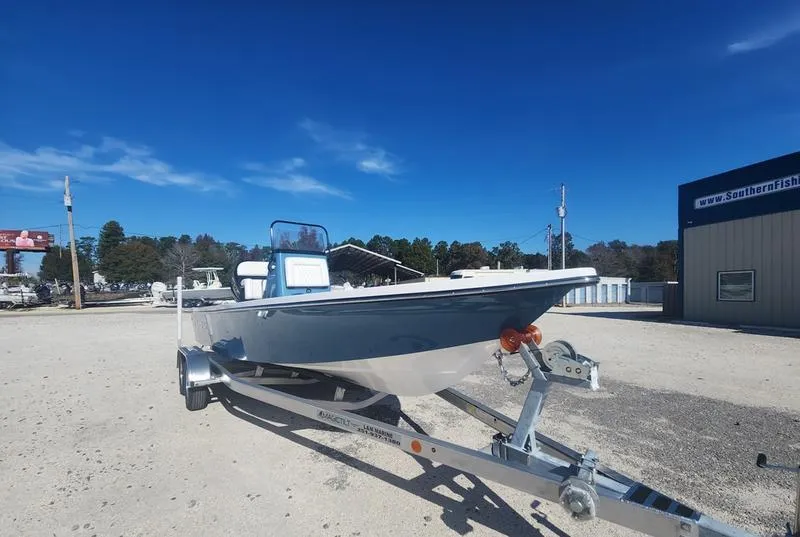 Slide: The Image of 2025 Blazer Bay 2200 boat on trailer under clear blue sky. - 5