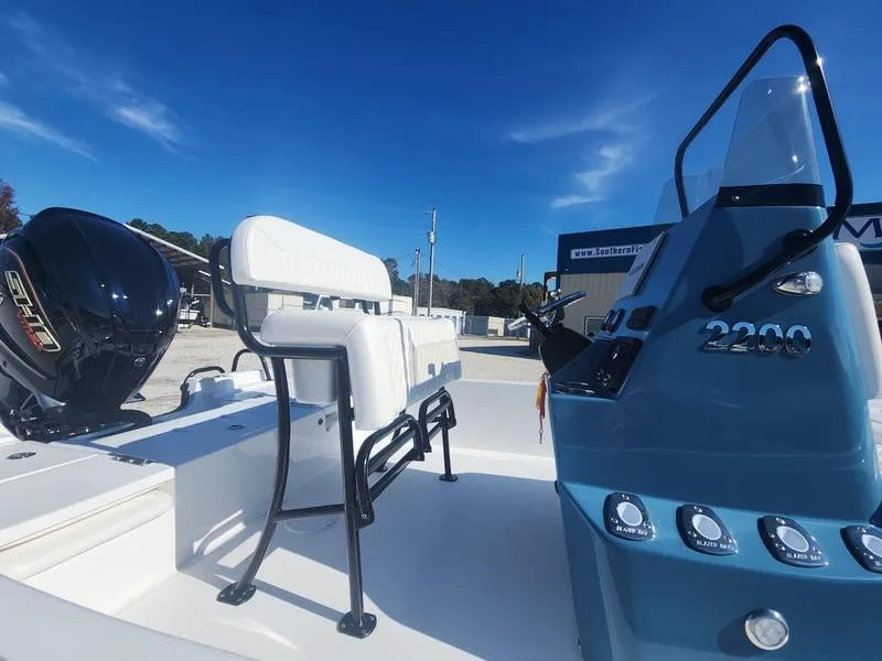 Slide: The Image of 2025 Blazer Bay 2200 boat with sleek design and modern controls under a clear blue sky. - 9