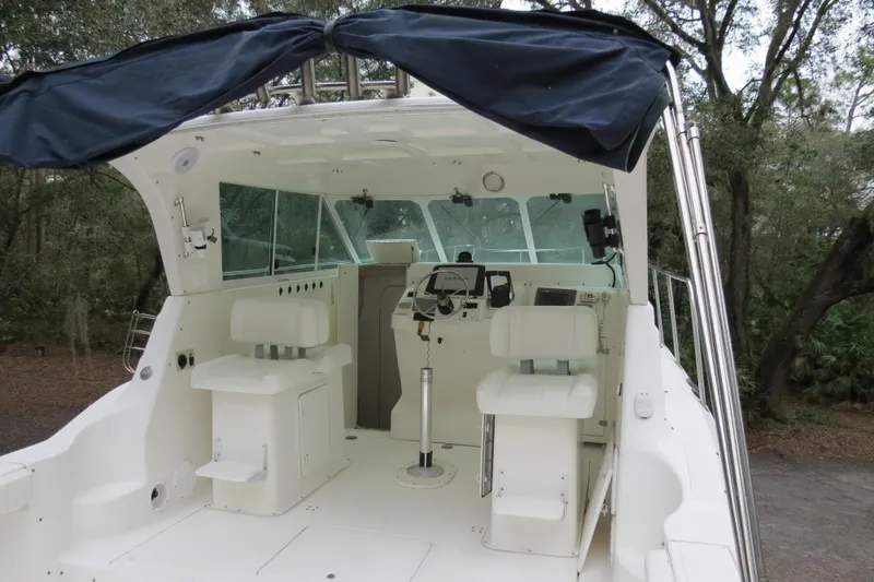 Slide: The Image of 2004 Baha Cruisers 290 King Kat boat interior with helm and seating area. - 10