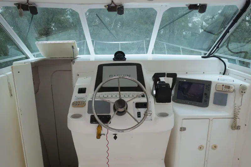 Slide: The Image of 2004 Baha Cruisers 290 King Kat boat helm with steering wheel and navigation equipment. - 11