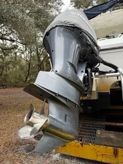 Slide: The Image of 2004 Baha Cruisers 290 King Kat boat engine with dual propellers in a wooded area. - 15