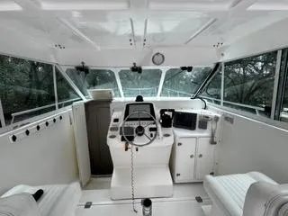 Slide: The Image of 2004 Baha Cruisers 290 King Kat boat interior with steering console and navigation equipment. - 19