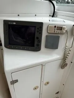 Slide: The Image of 2004 Baha Cruisers 290 King Kat boat dashboard with navigation equipment and radio. - 23
