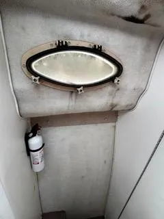 Slide: The Image of 2004 Baha Cruisers 290 King Kat interior with porthole and fire extinguisher. - 26