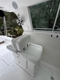 Slide: The Image of 2004 Baha Cruisers 290 King Kat interior with white seating and window view. - 27