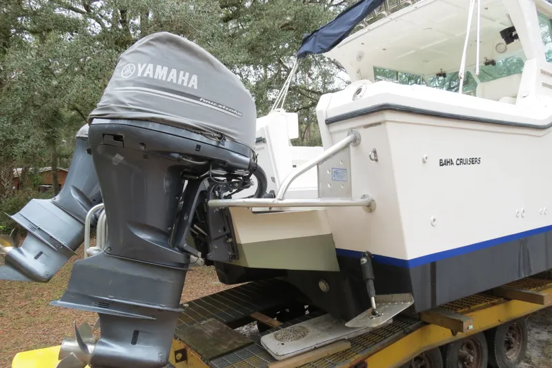 Slide: The Image of 2004 Baha Cruisers 290 King Kat boat with Yamaha outboard motor on trailer. - 3