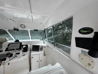 Slide: The Image of 2004 Baha Cruisers 290 King Kat boat interior with steering wheel and navigation equipment. - 30