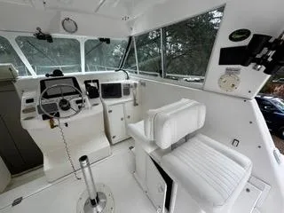 Slide: The Image of 2004 Baha Cruisers 290 King Kat boat interior with steering wheel and seating. - 31