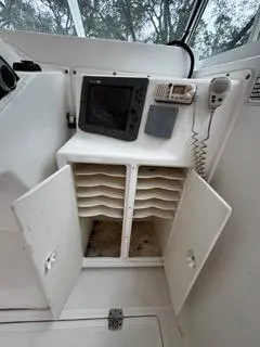 Slide: The Image of 2004 Baha Cruisers 290 King Kat boat interior with navigation equipment and storage compartments. - 32