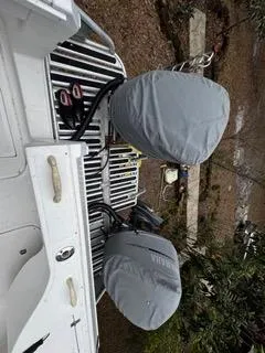 Slide: The Image of 2004 Baha Cruisers 290 King Kat with covered outboard motors on a trailer. - 34