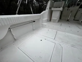 Slide: The Image of 2004 Baha Cruisers 290 King Kat boat deck, featuring spacious seating and storage compartments. - 36