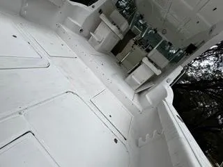 Slide: The Image of 2004 Baha Cruisers 290 King Kat boat interior, featuring spacious white deck and seating area. - 38