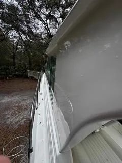 Slide: The Image of 2004 Baha Cruisers 290 King Kat boat side view with trees in the background. - 40