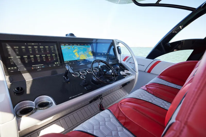 Slide: The Image of Cockpit of 2017 Midnight Express 43' Open boat with red seats and navigation display. - 10