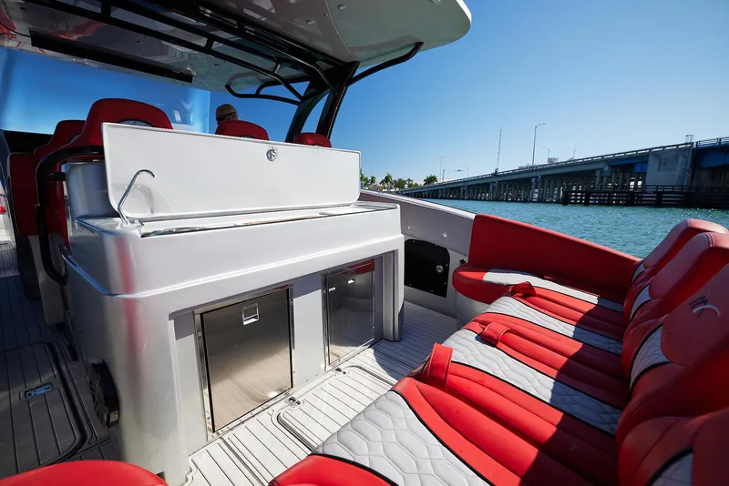 Slide: The Image of 2017 Midnight Express 43' Open boat with red seating, sleek design, and bridge view. - 14
