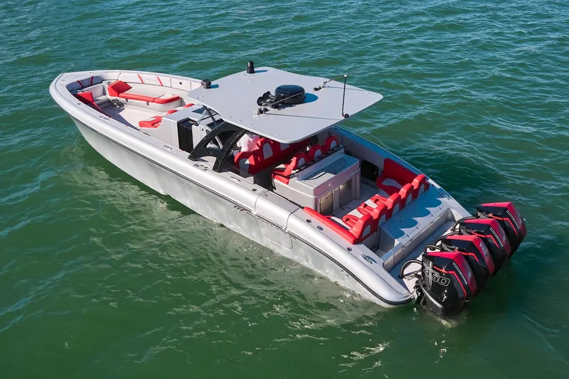 Slide: The Image of 2017 Midnight Express 43' Open boat with red seating, cruising on clear water. - 4