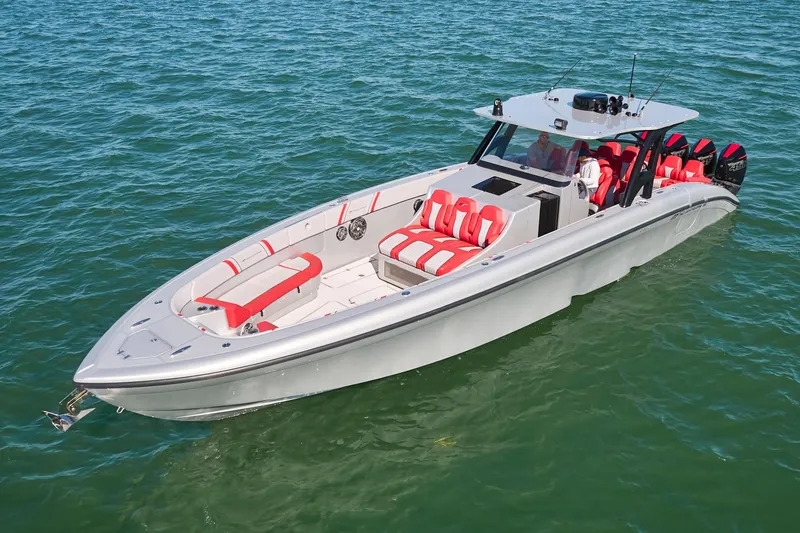 Slide: The Image of 2017 Midnight Express 43' Open boat with red and white seating on clear water. - 5